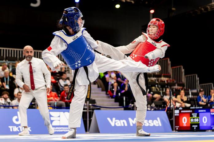 Two female Para taekwondo athletes competing