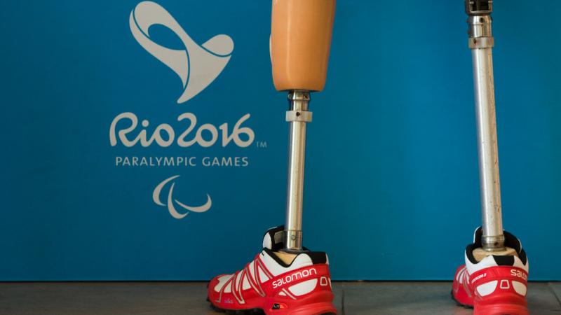 a pair of prosthetic legs next to the Rio 2016 emblem
