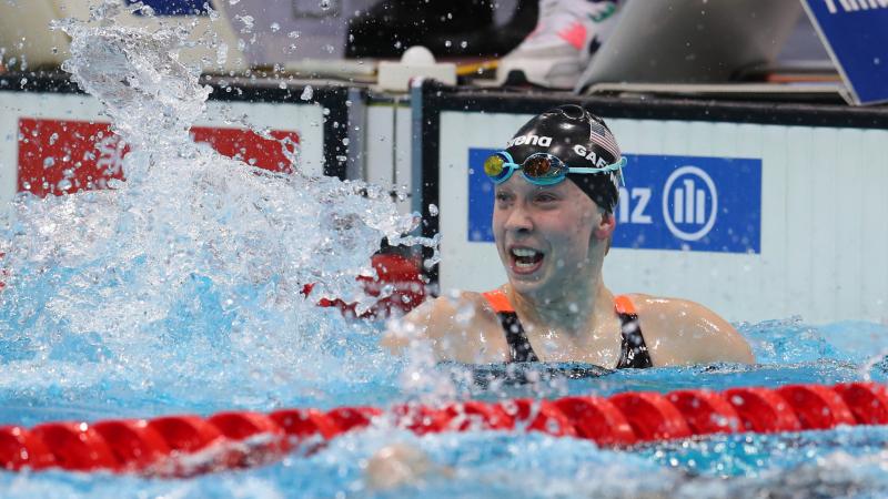US female swimmer splashes water to celebrate