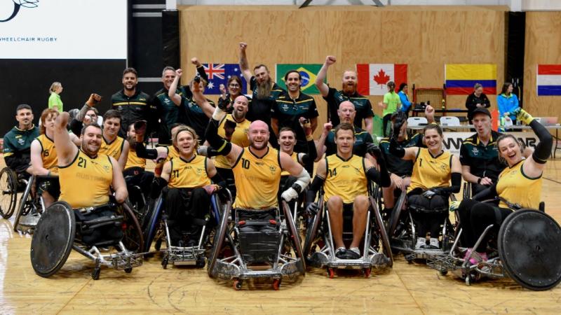 About 20 wheelchair rugby players and officials pose for a photograph