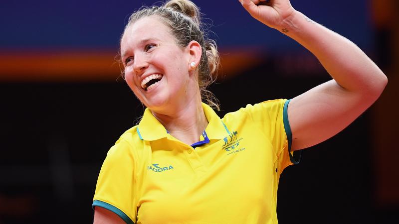 female Para table tennis player Melissa Tapper pumps her fist in victory