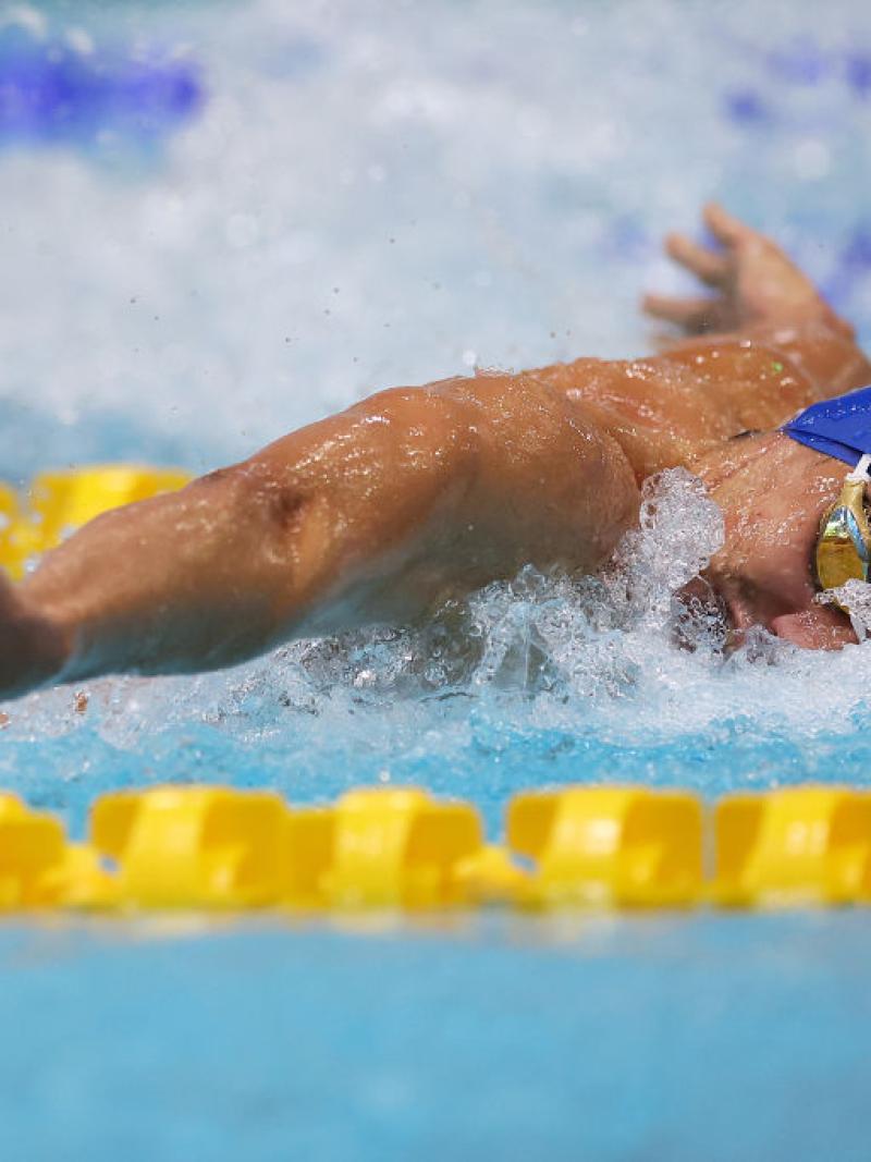 A male swimmer competing in butterfly