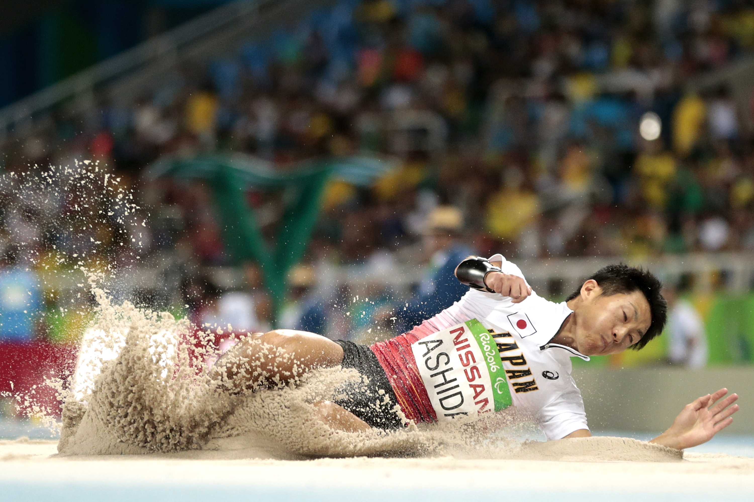 Japanese man completes long jump in sand