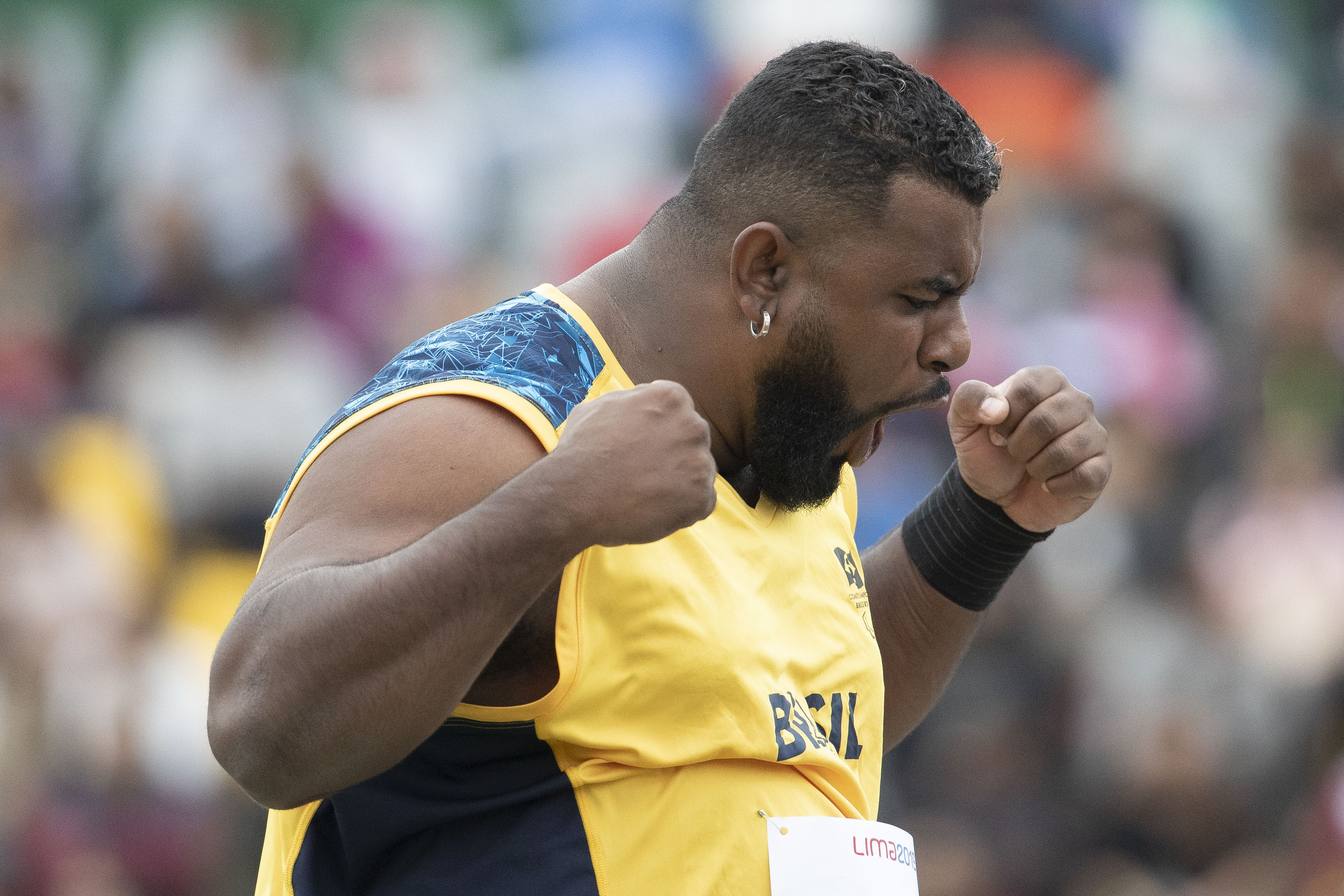 a male Para athlete screams in celebration with his fists clenched