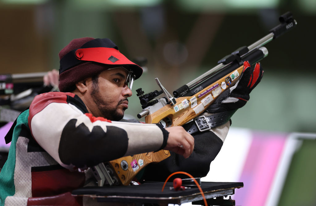 A male shooter with a rifle in a shooting range