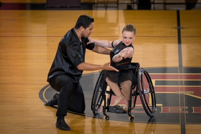 A female wheelchair dancer with a standing male partner