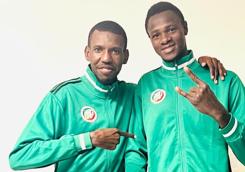 Idrissa Keita, a Para taekwondo athlete from Senegal, and his coach pose for a photograph