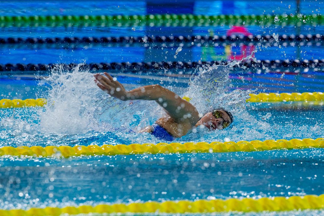 A female swimmer competing in a pool