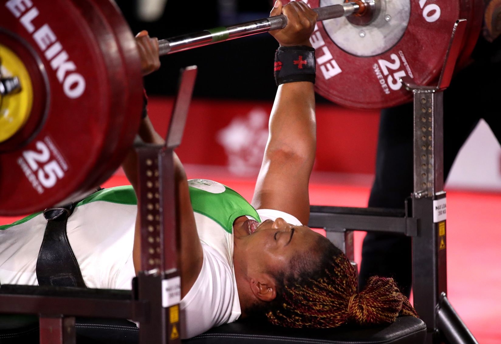 Lucy Ejike of Nigeria lifts weights during competition