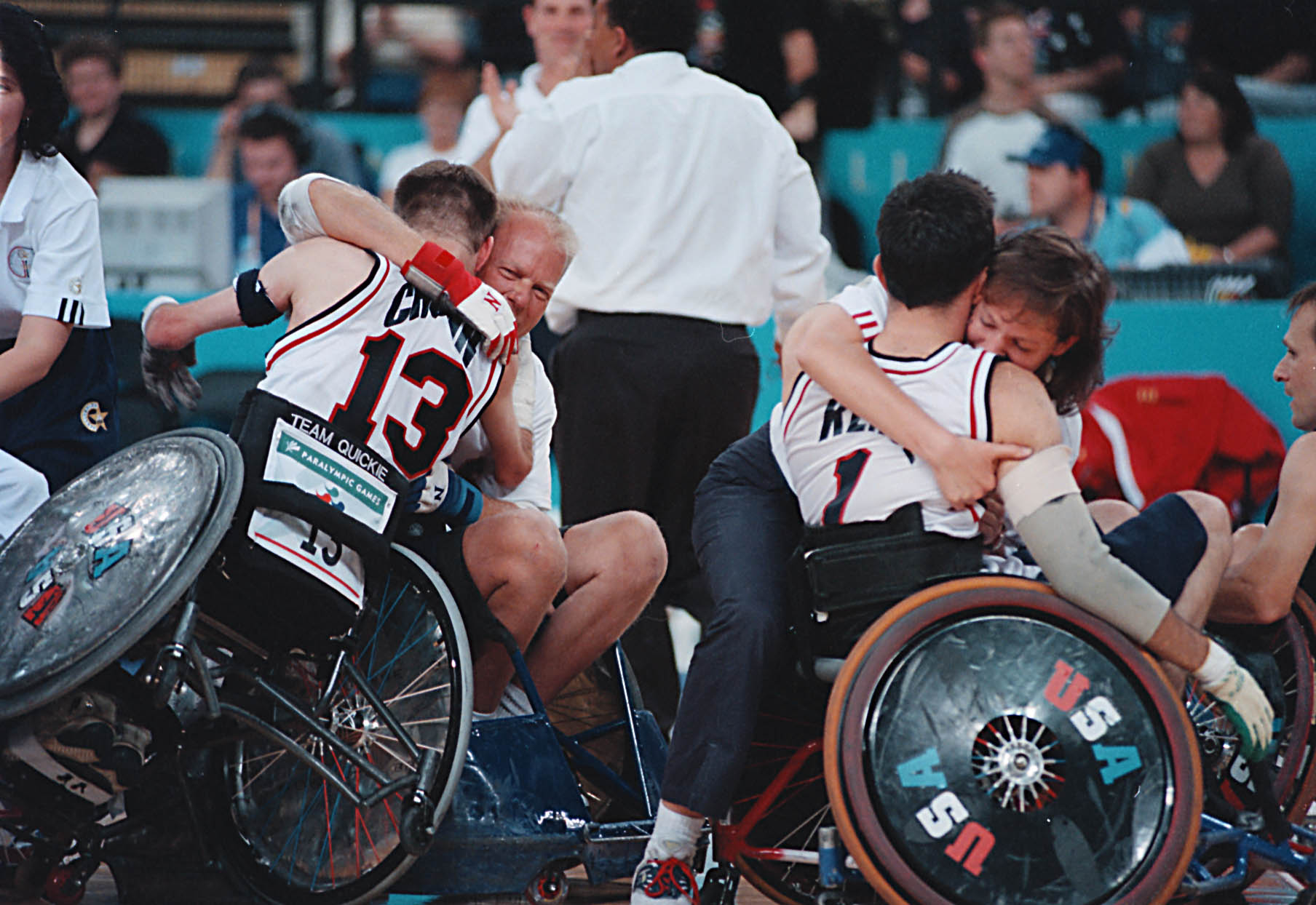 A picture of a man in a wheelchair and a girl celebrating a victory.
