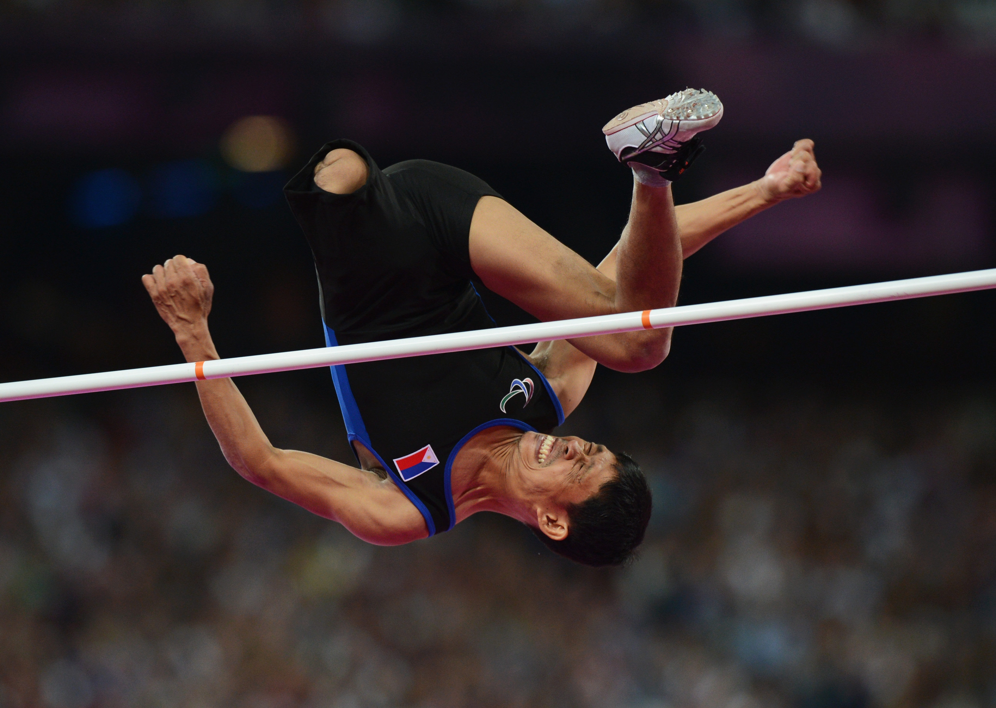 Andy Avellana of the Philippines jumps over the bar in the men's high jump.