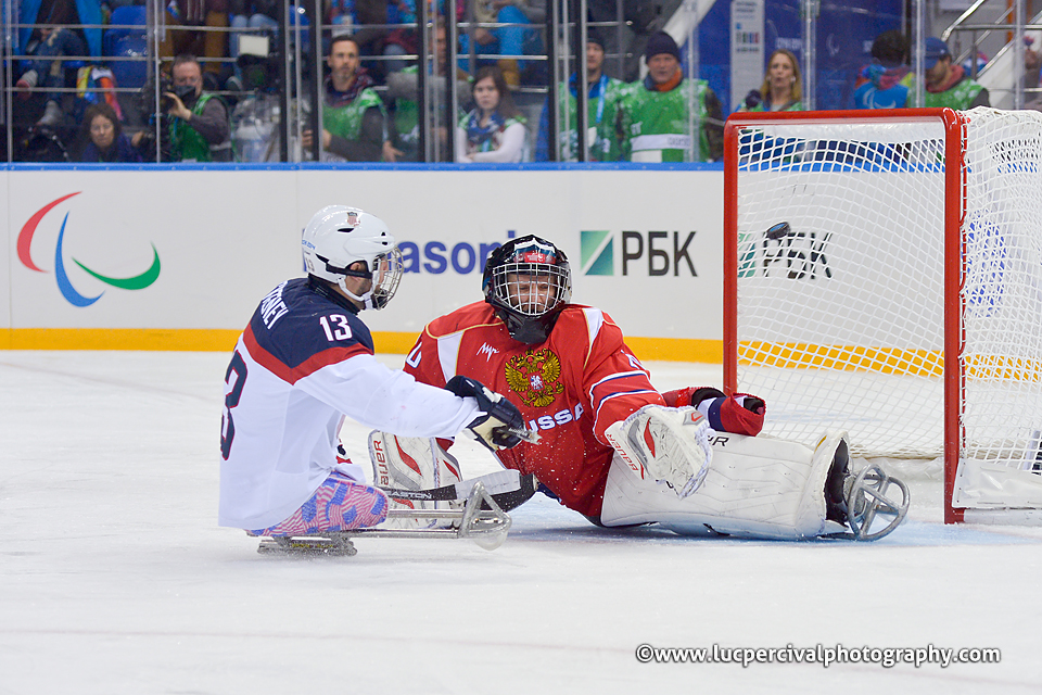 The USA's Josh Sweeney crashes the net during the Sochi 2014 Paralympic Winter Games.
