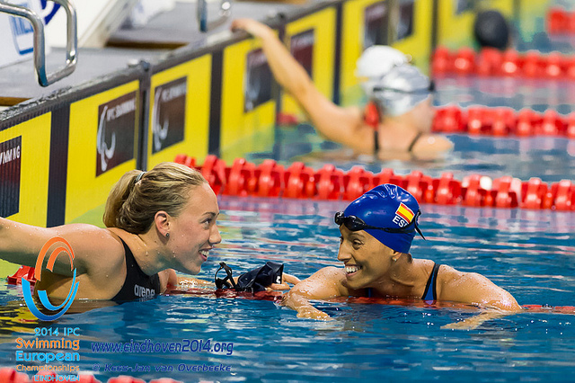 Two swimmers smile at each other after competing at the 2014 IPC Swimming European Championships