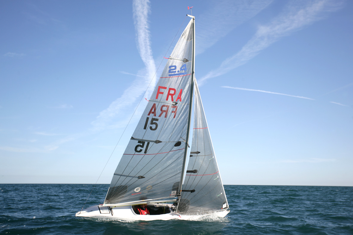Man inside sailing boat with FRA and 15 written on the sail