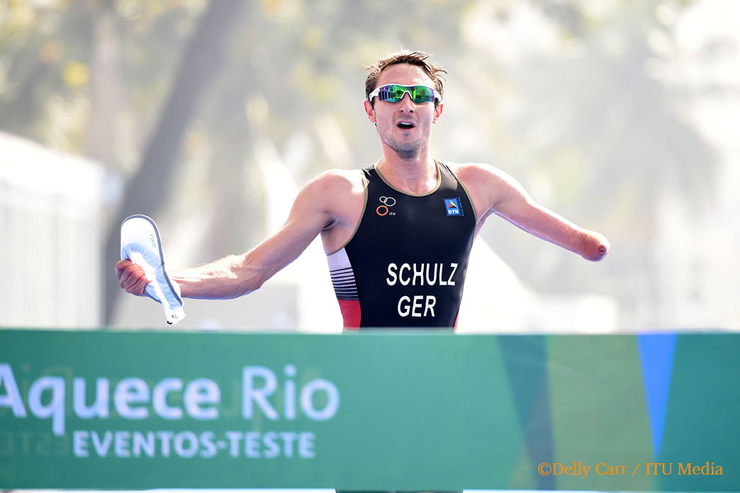 Man with an arm amputation crossing a finish line