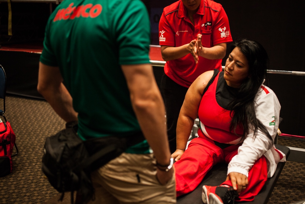 Woman sitting on a bench, preparing for her competition