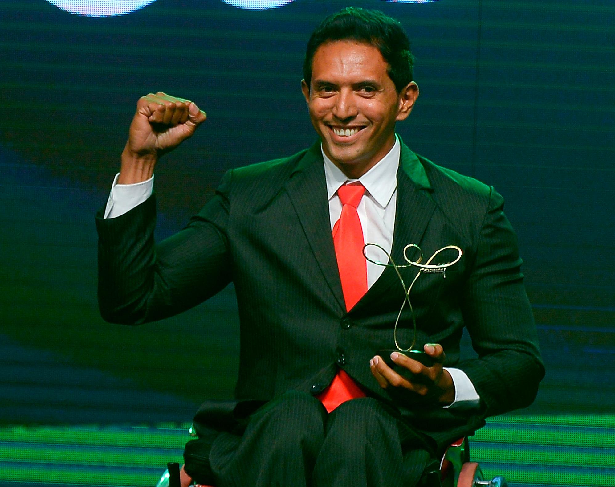Luis Carlos Cardoso da Silva poses with his trophy won in the Paracanoe category of the Brazil Paralympics 2014 Awards Ceremony.