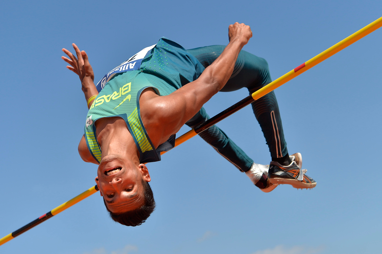 Brazilian athlete clears a bar in the high jump