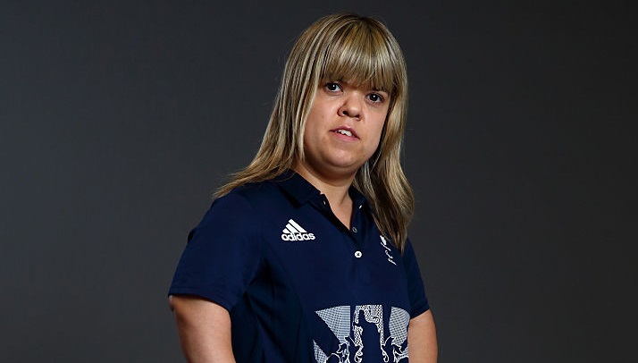 a female powerlifter looks into the camera