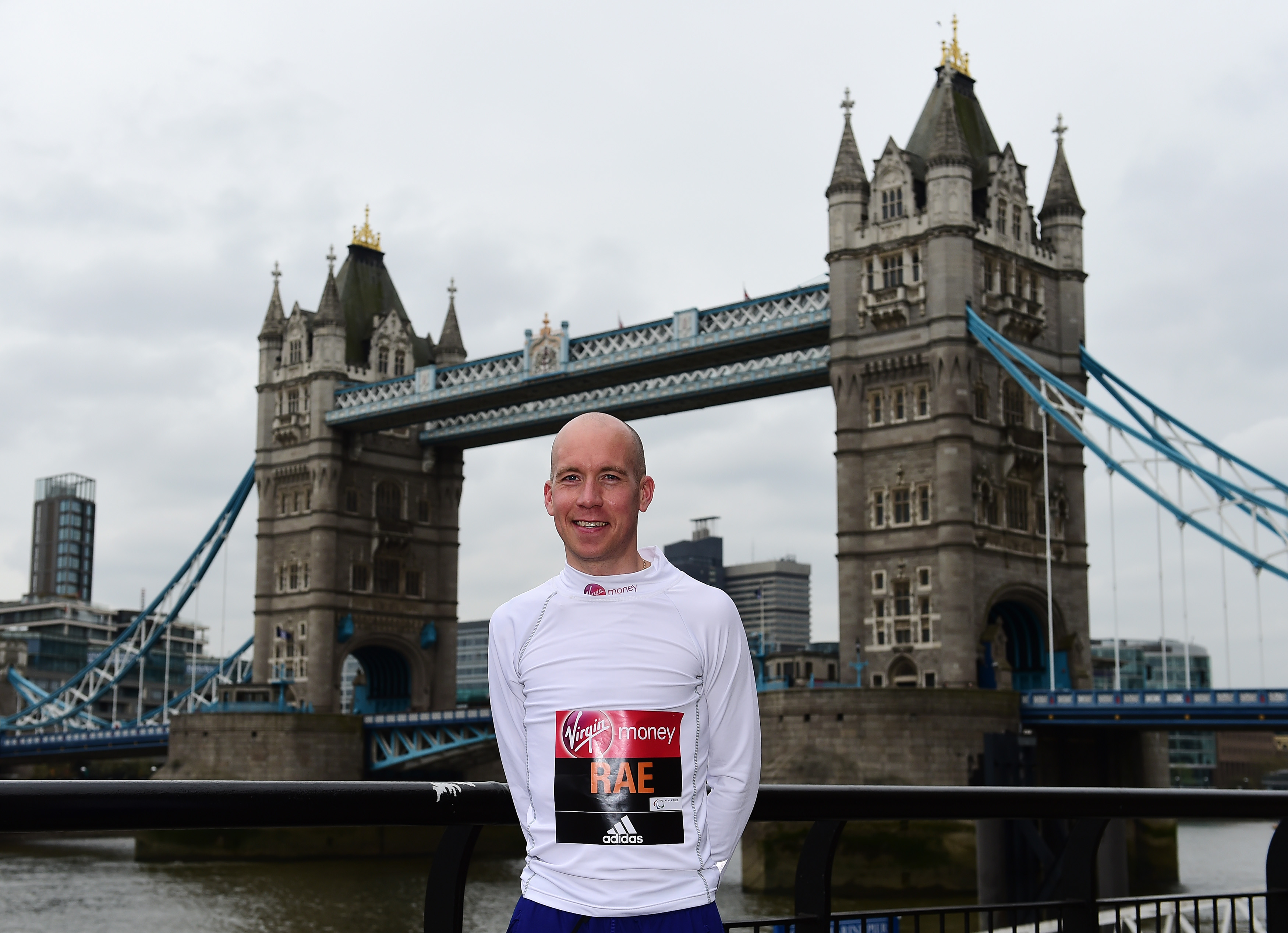 a man standing in front of London's Tower Bridge