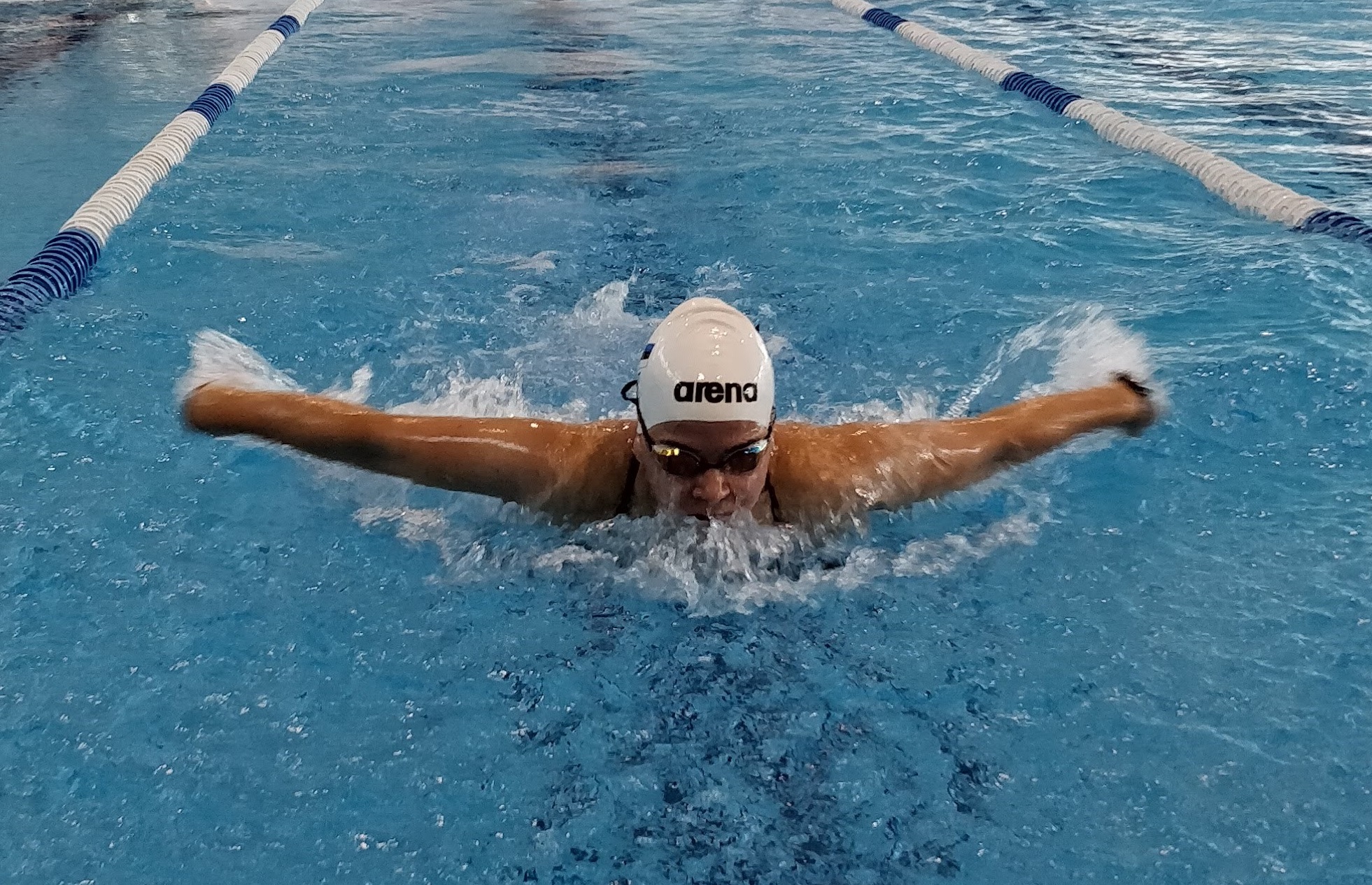 a female Para swimmer mid-stroke