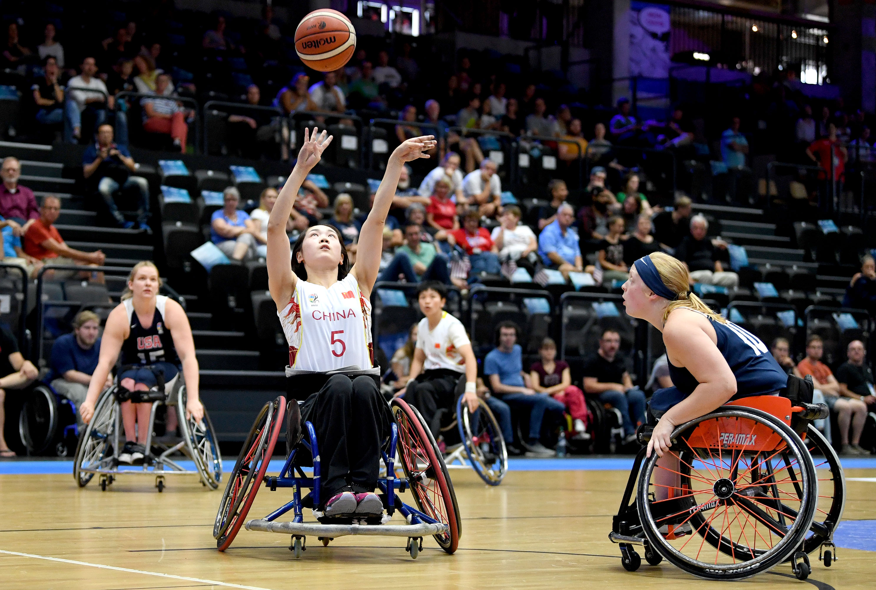 female wheelchair basketballer Xuemei Zhang challenges for the ball