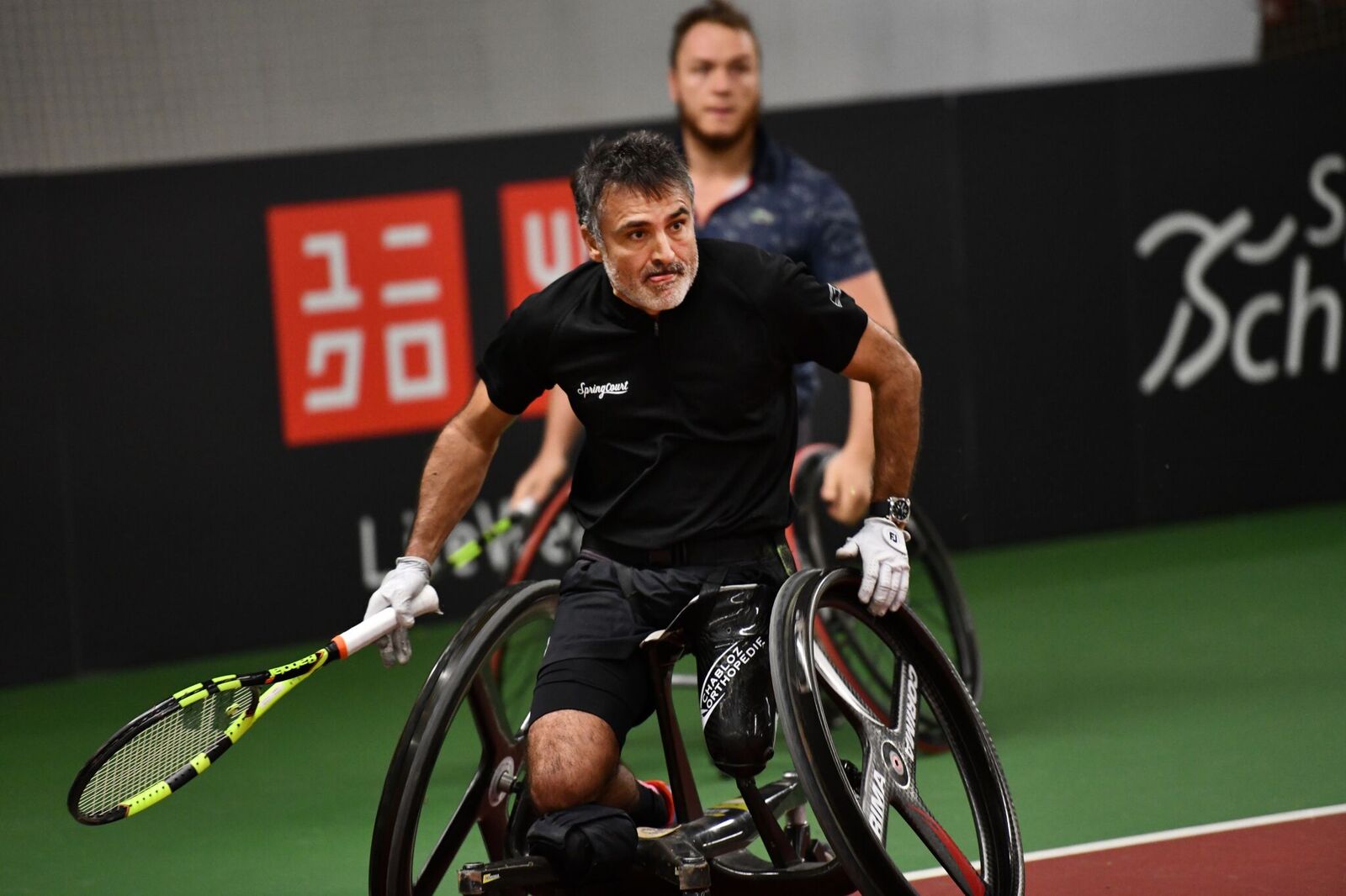 male wheelchair tennis players Stephane Houdet and Nicolas Peifer in action on court