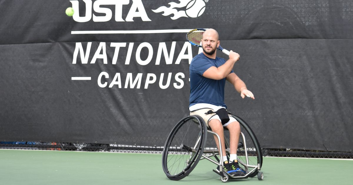 male wheelchair tennis player Stefan Olsson plays a forehand on a hard court