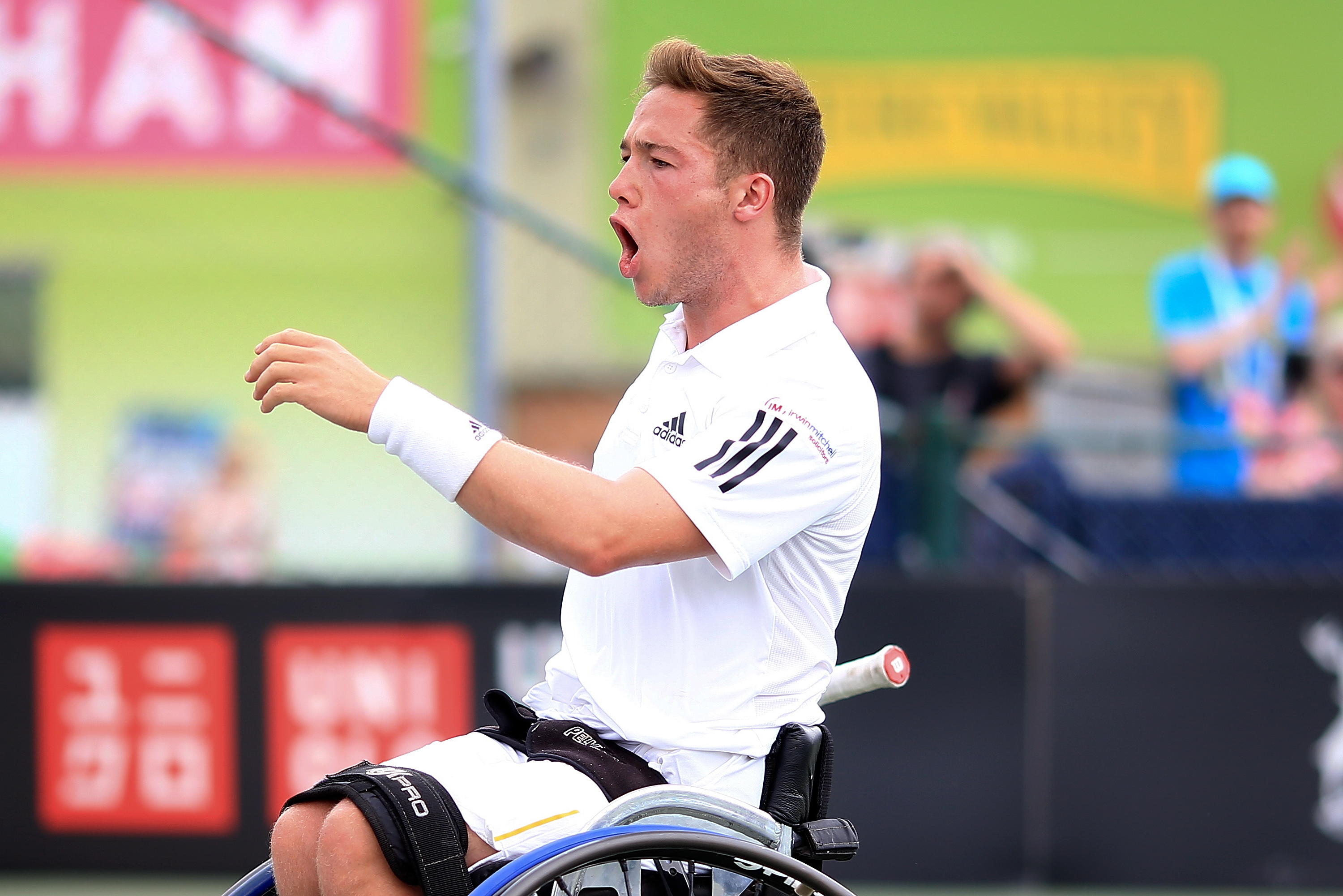 male wheelchair tennis player Alfie Hewett yells in triumph after winning a point