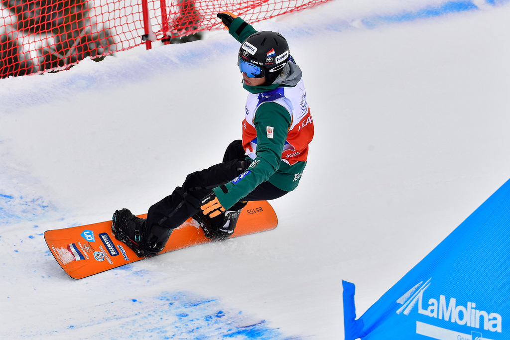 male Para snowboarder Chris Vos goes round a banked slalom bend