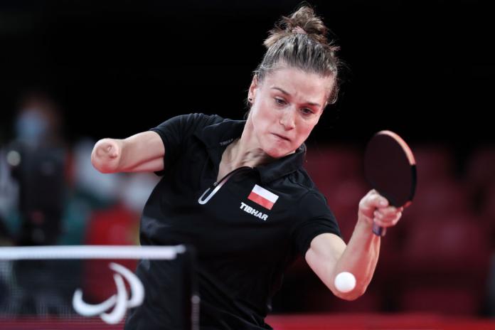 Woman returns ball in table tennis