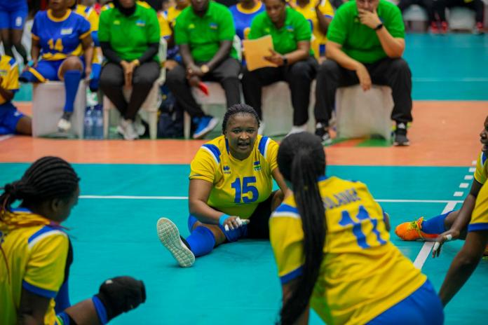 Female sitting volleyball athletes communicating on the court