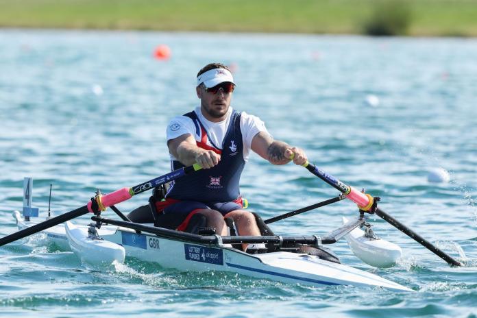 A male Para rower in action.