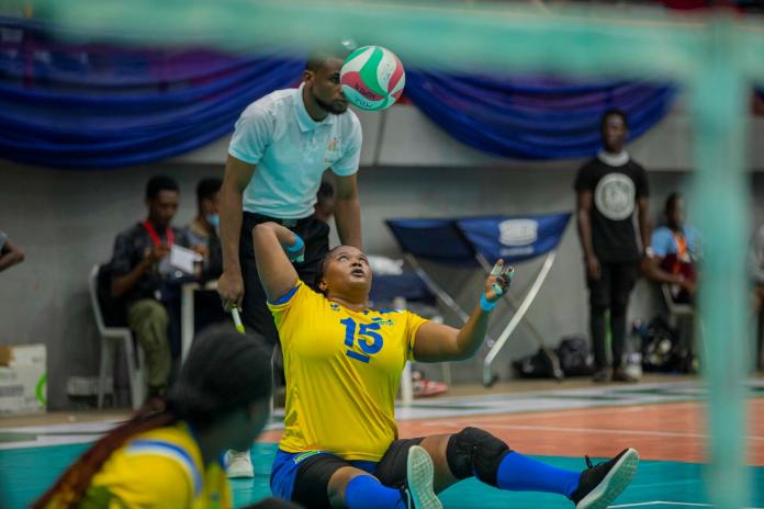 Female sitting volleyball serving the ball