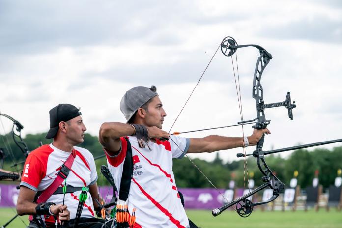 A male Para athlete shooting an arrow during competition