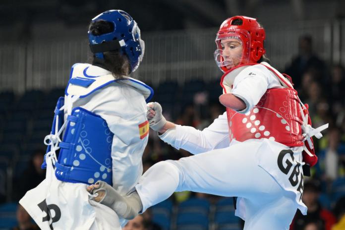 A female athlete kicks her opponent