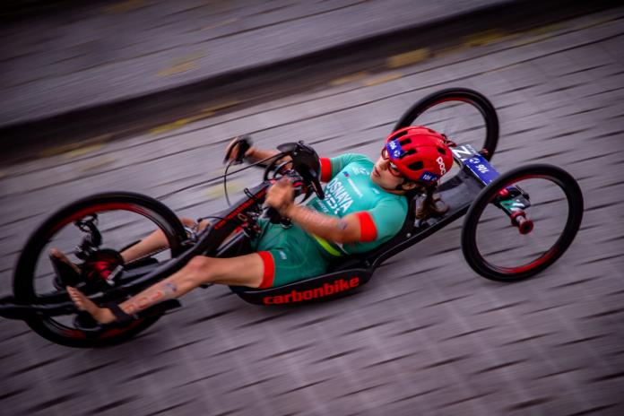 A female Para triathlete competes in a handcycle
