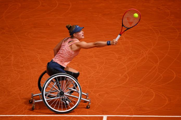 A female wheelchair tennis athlete in action at the French Open