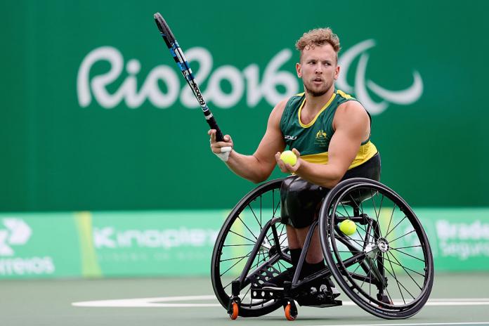 A male wheelchair tennis player in action at the Rio 2016 Paralympics.