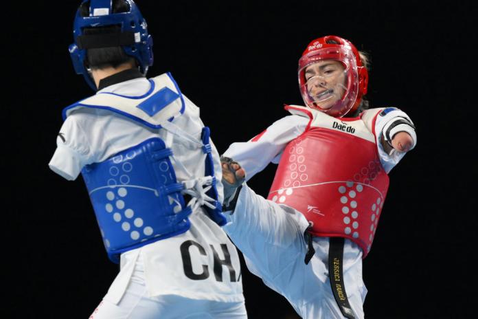 Two female Para taekwondo athletes in action
