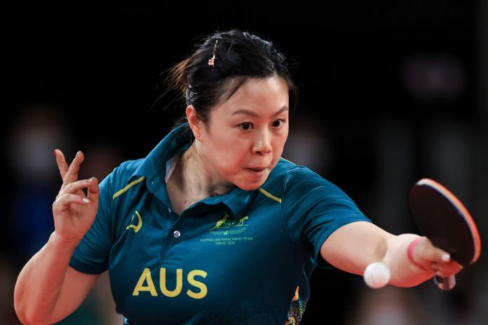 A female Para table tennis player in action.