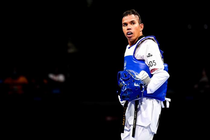 A male athlete wearing a blue gear