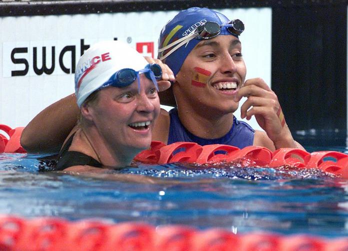Beatrice Hess of France and Maria Teresa Perales of Spain celebrate together in the pool after a race
