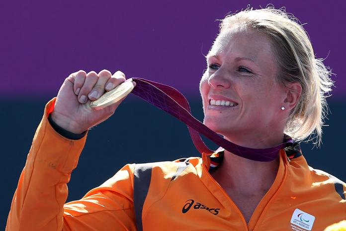 Esther Vergeer poses with a  gold medal.