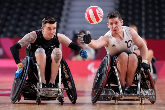 Two male wheelchair rugby players in action