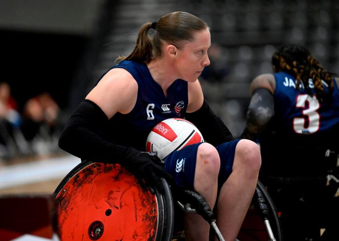 Sarah Adam carries the ball during a wheelchair rugby match