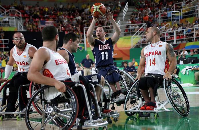A male wheelchair basketball player attempts a throw
