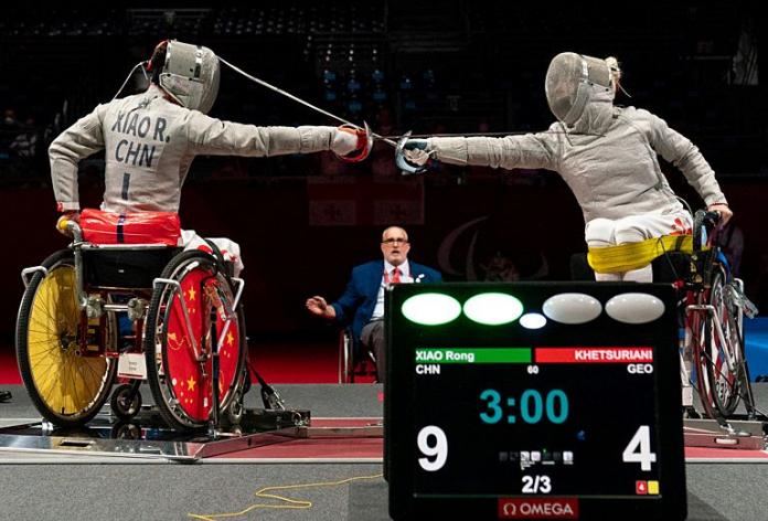 Two wheelchair fencing athletes in action