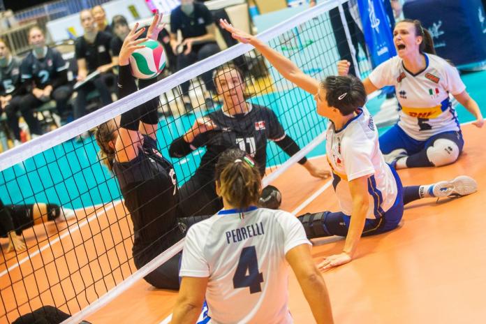 Three female sitting volleyball players in action