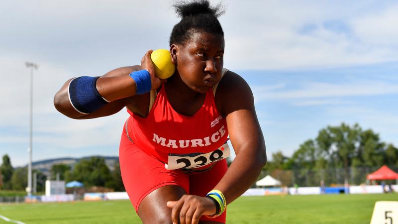 Teenage Mauritian female athlete prepares to release shot put